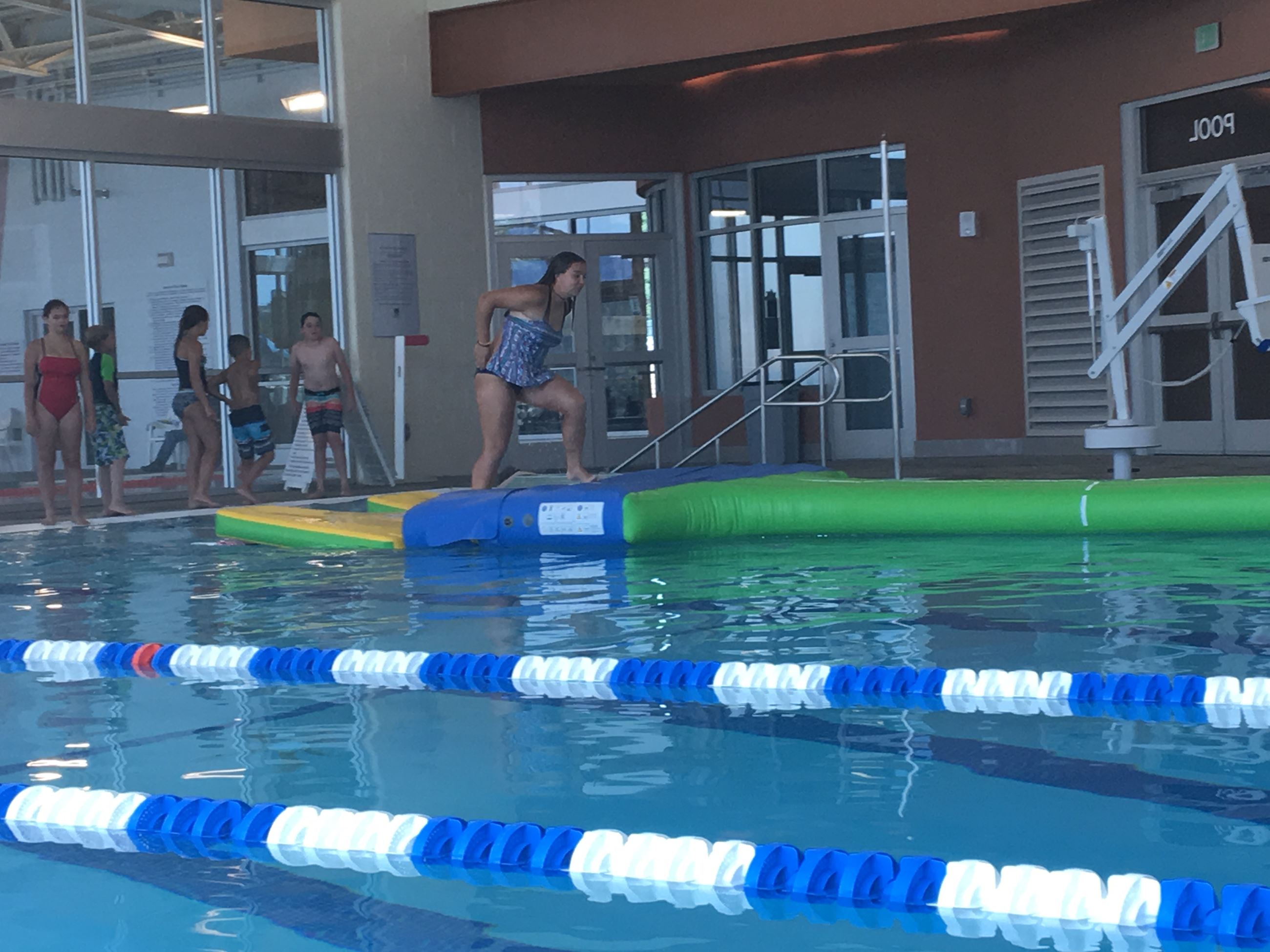 Young Girl Jumping into Pool