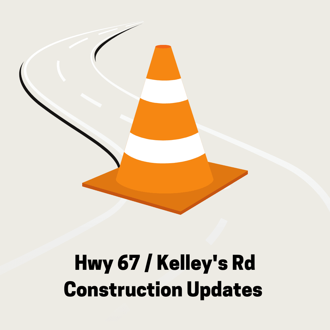 Traffic cone on a road and text 