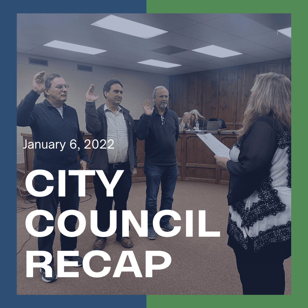 3 Men taking an oath of office in city council chambers