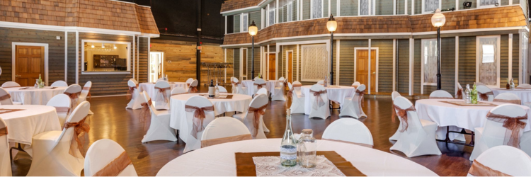 Photo of the UPCC staged for a wedding with tables with white linens