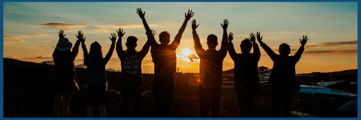People standing together by sunset